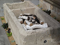 a contemporary simple hand carved stone fireplace surround